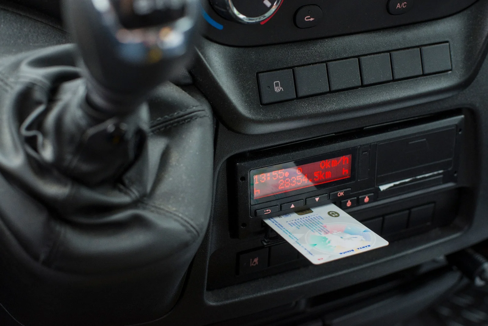 Digital tachograph unit fitted inside a van cab dashboard showing card slot and display